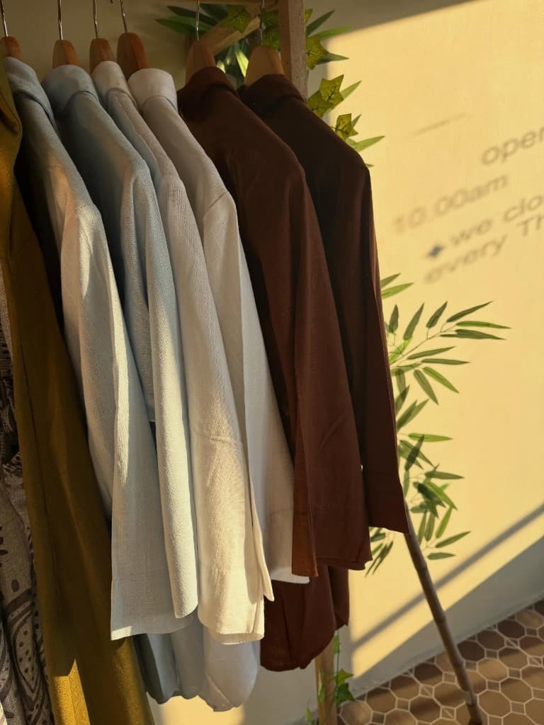 Wooden clothing rack bathed in golden-hour light